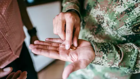 military person holding their ring